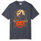 A  short-sleeve crewneck t-shirt featuring a Halloween graphic print of a glowing jack-o'-lantern pumpkin, a haunted house, bats, and a full moon.