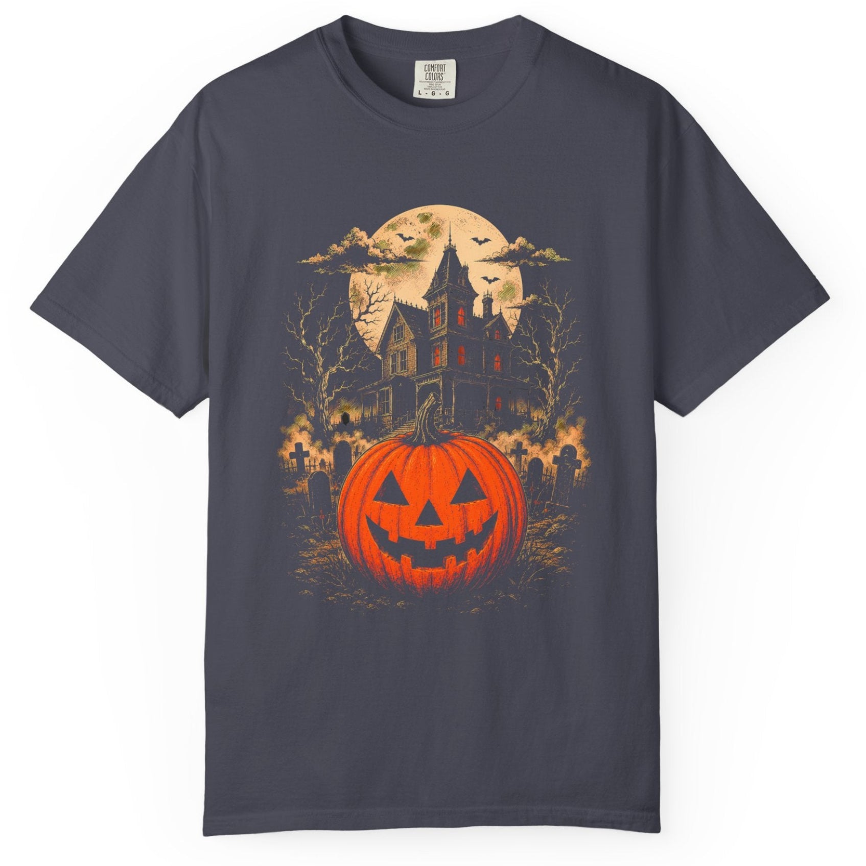A  short-sleeve crewneck t-shirt featuring a Halloween graphic print of a glowing jack-o'-lantern pumpkin, a haunted house, bats, and a full moon.
