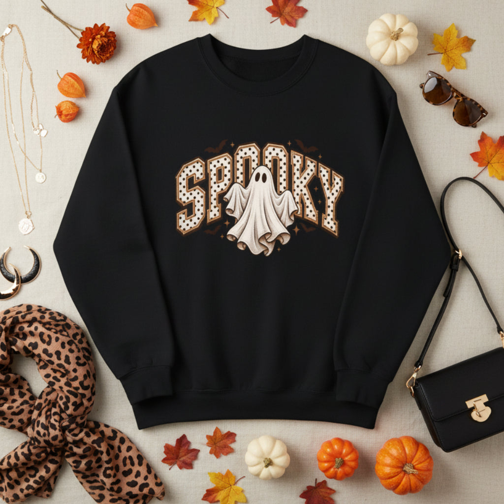 A black crewneck sweatshirt featuring a 'Spooky' graphic on the chest with a white ghost and brown polka-dot details, displayed on a clean white background.