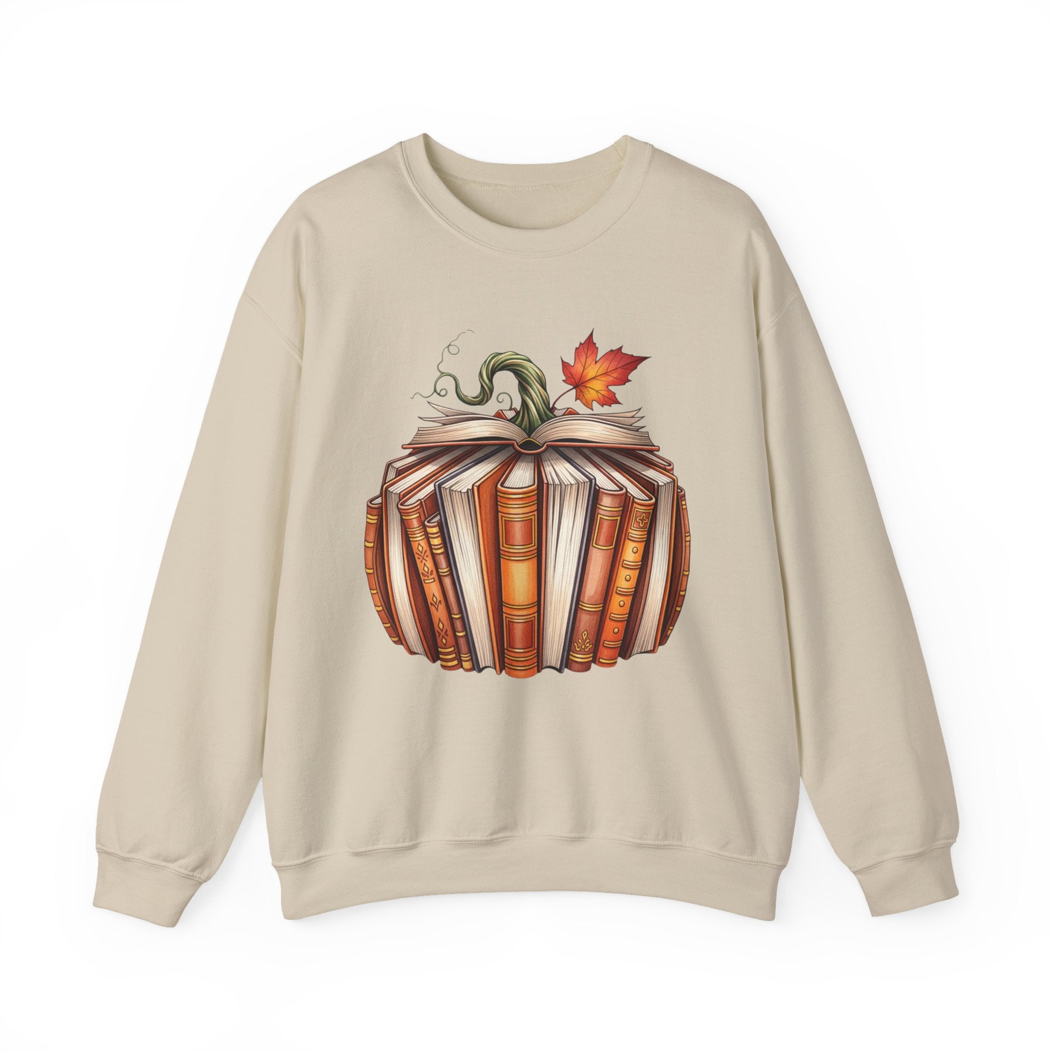 A beige crewneck sweatshirt featuring a graphic print of a pumpkin made of stacked books with a green vine and an orange autumn leaf on top, displayed against a plain white background.