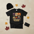 A black short-sleeve crewneck t-shirt featuring a square Halloween-themed graphic print on the front with illustrations of a skeleton, ghosts, a jack-o'-lantern, a crescent moon, and the text 'SPOOKY VIBES ONLY'.