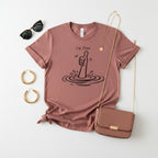 A pink short-sleeve crewneck t-shirt featuring a black graphic of a hand giving a thumbs-up with ripples and the text 'i'm fine' printed on the chest.