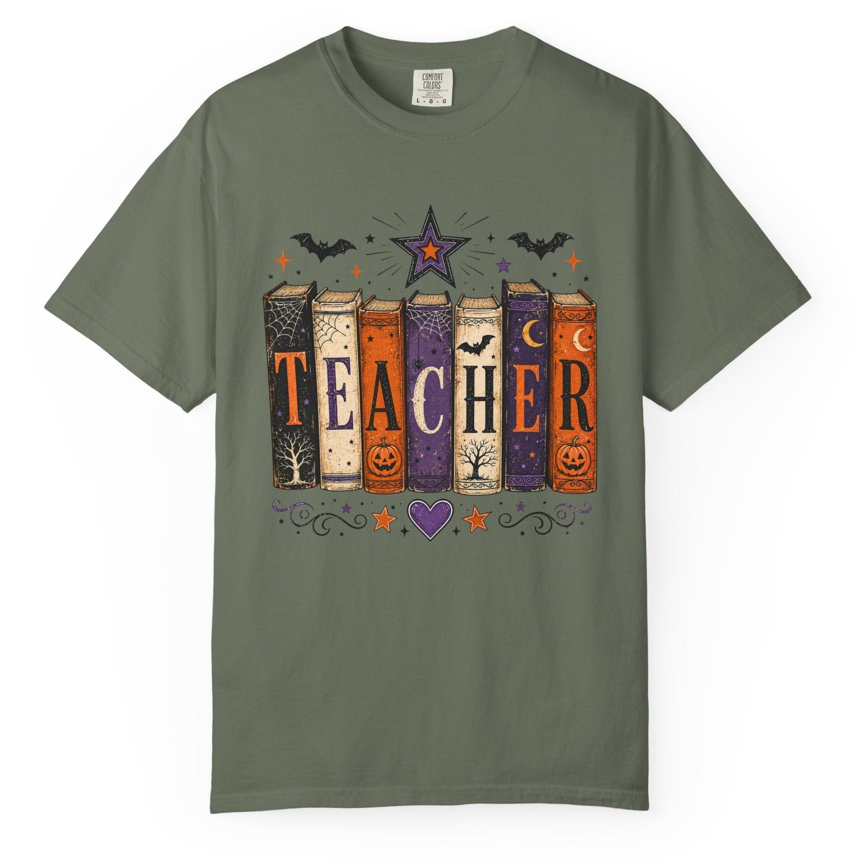 An olive green short-sleeve t-shirt with a graphic print of six colorful books spelling 'TEACHER' decorated with Halloween motifs like pumpkins, bats, and stars, shown on a plain white background.
