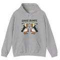 Gray hoodie with two geese dressed as vampires doing fist bumps