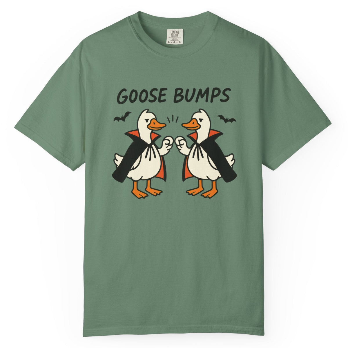 A light green short-sleeve t-shirt with a graphic of two geese in black and orange, with the text 'GOOSE BUMPS' above them
