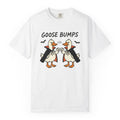 A white short-sleeve crewneck t-shirt featuring a graphic of two cartoon geese in black and orange vampire costumes bumping fists, with the text 'GOOSE BUMPS' above them.