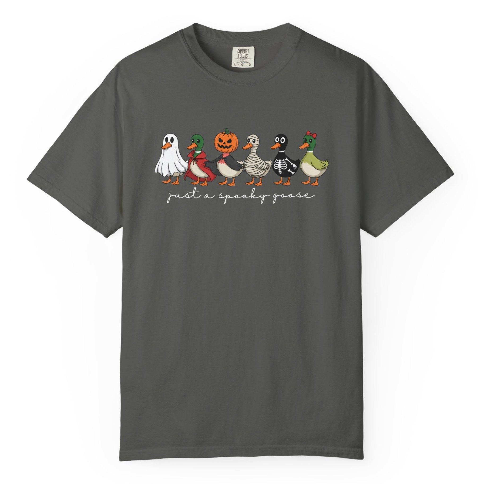 A pepper crewneck t-shirt featuring a graphic of six cute cartoon ducks dressed in Halloween costumes, with the text 'just a spooky goose' printed below them.