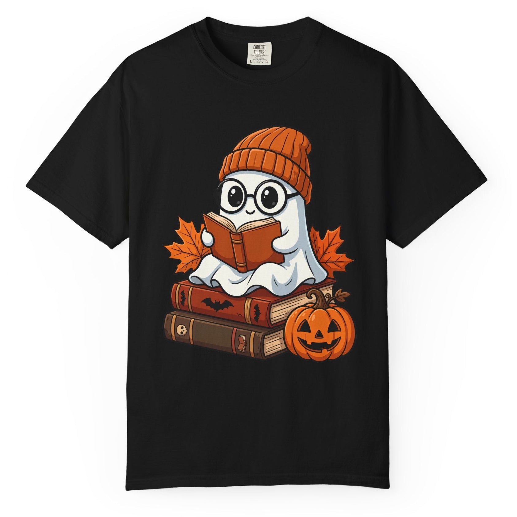 A black short-sleeve crewneck t-shirt featuring a cartoon graphic of a ghost wearing glasses and an orange knit beanie, sitting on books and reading an orange book, with autumn leaves and a jack-o'-lantern pumpkin.