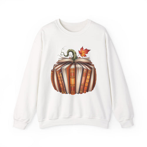 An white crewneck sweatshirt featuring a graphic of a pumpkin made of stacked books with a green stem and an orange autumn leaf on top, displayed against a solid white background.