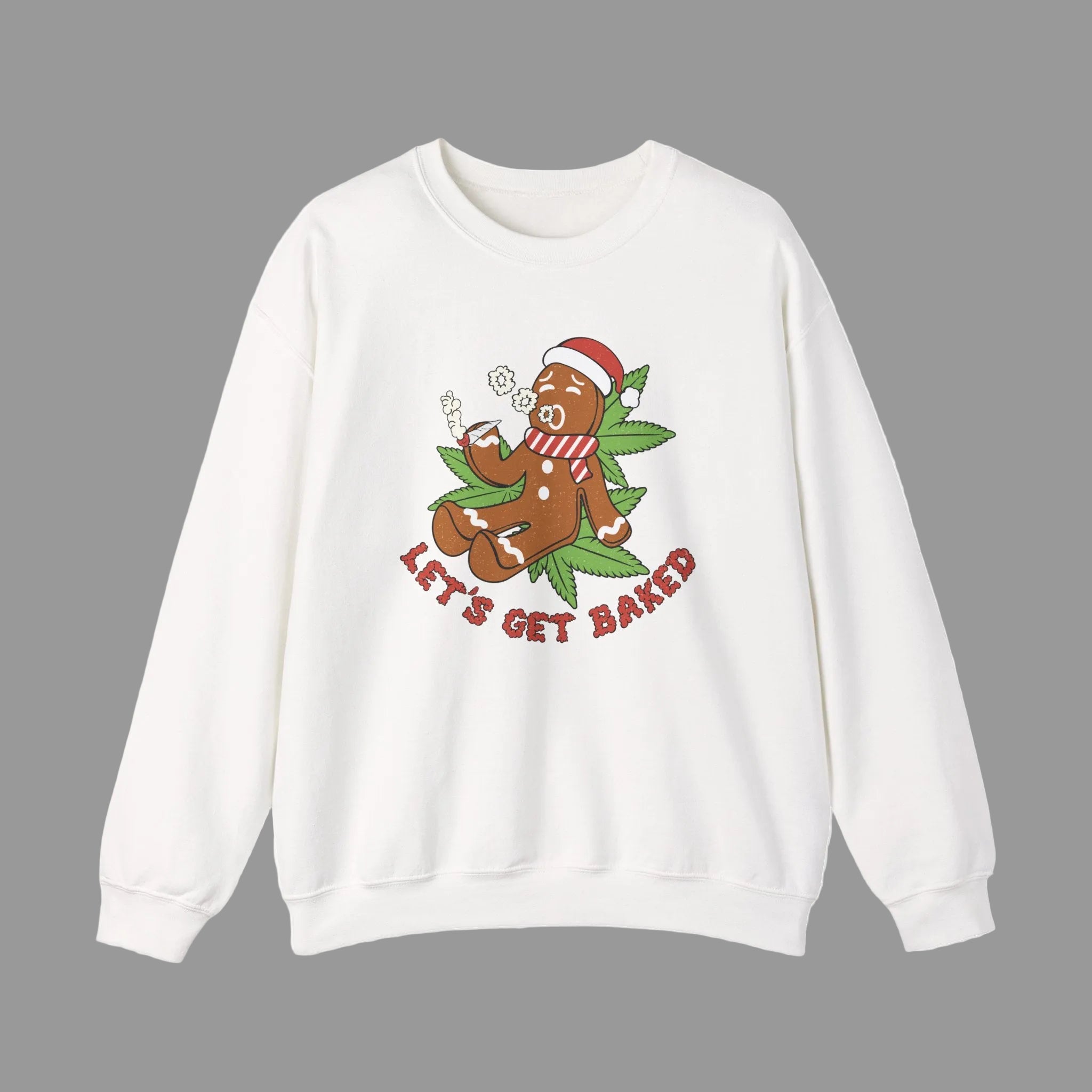 A white crewneck sweatshirt featuring a festive graphic of a gingerbread man wearing a Santa hat and scarf, sitting on marijuana lead smoking a spliff with the text 'LET'S GET BAKED' in red below