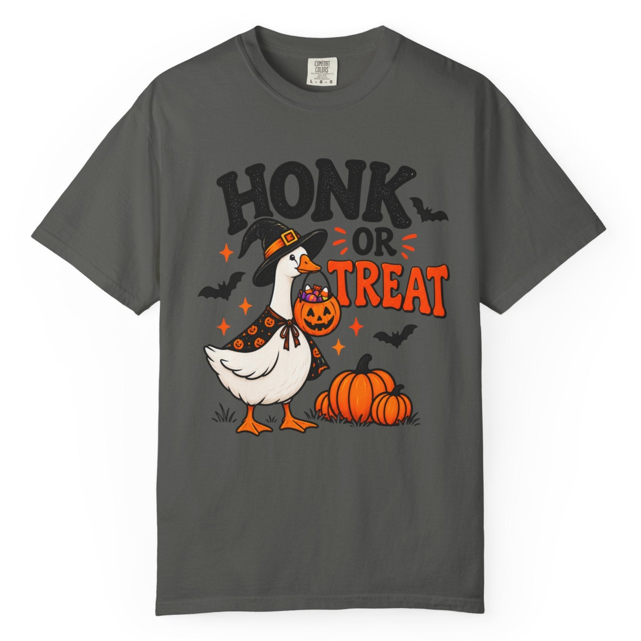 A dark gray short-sleeve t-shirt with a Halloween graphic on the front. The graphic features a white goose wearing an orange witch hat and a pumpkin patch next to two orange pumpkins, with the text 'HONK OR TREAT' in black and orange.