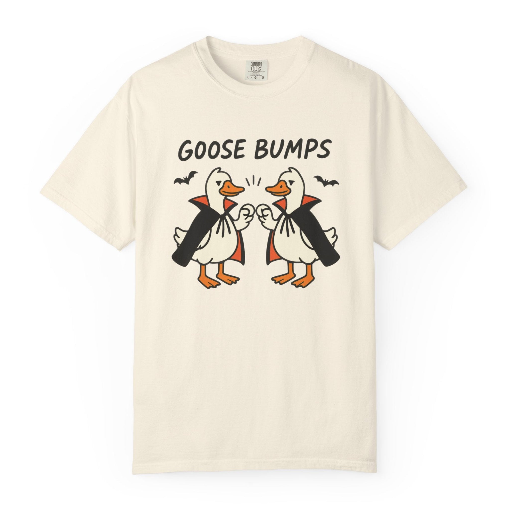 A ivory short-sleeve t-shirt with a graphic of two geese in black and orange, with the text 'GOOSE BUMPS' above them, displayed on a clean white background.
