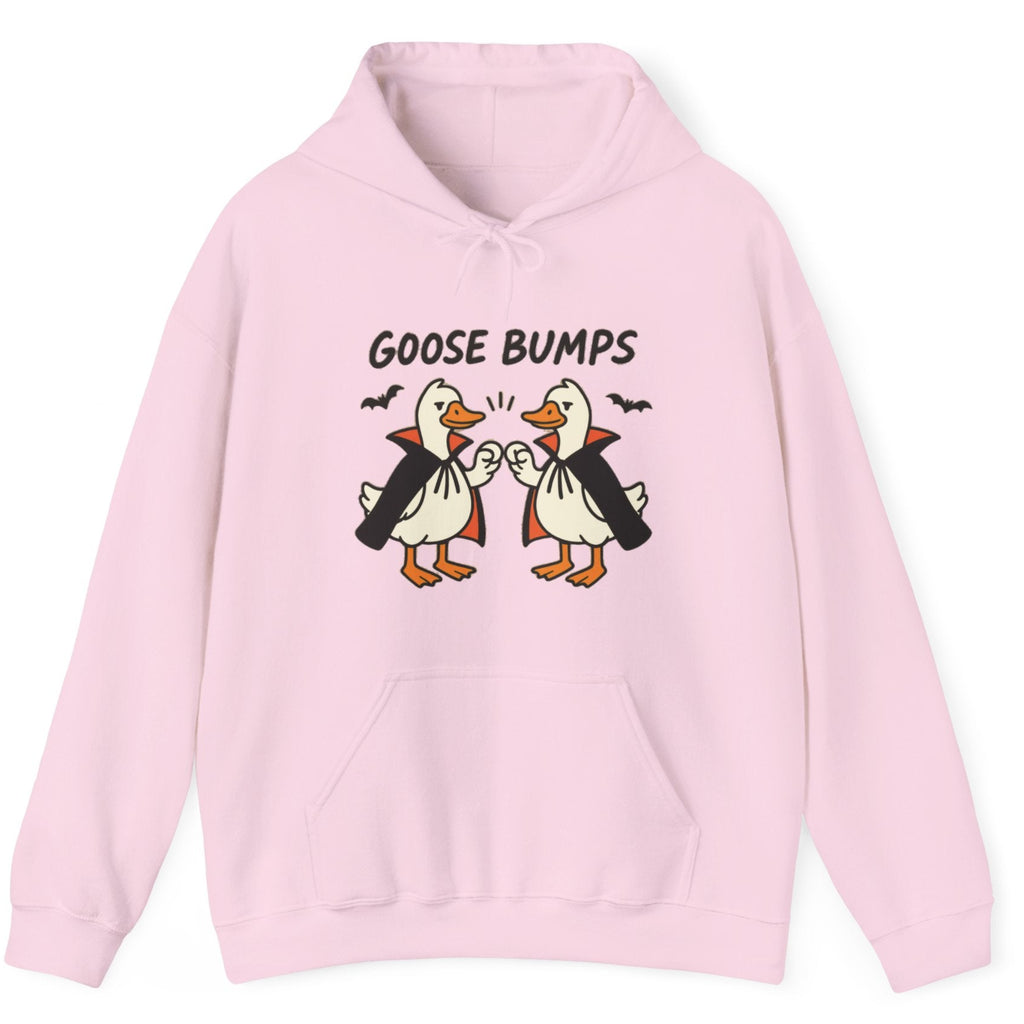 A light pink pullover hoodie featuring a graphic of two cartoon geese in vampire costumes bumping fists with the text 'GOOSE BUMPS' above them, displayed on a clean white background.