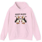 A light pink pullover hoodie featuring a graphic of two cartoon geese in vampire costumes bumping fists with the text 'GOOSE BUMPS' above them, displayed on a clean white background.