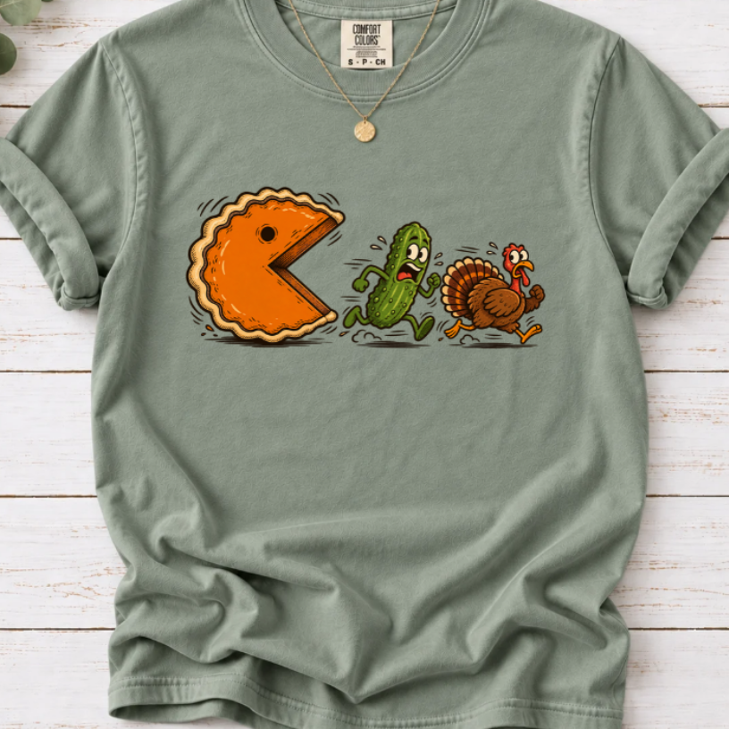 Bay T-shirt featuring a cartoon pumpkin pie chasing a frightened pickle and turkey.