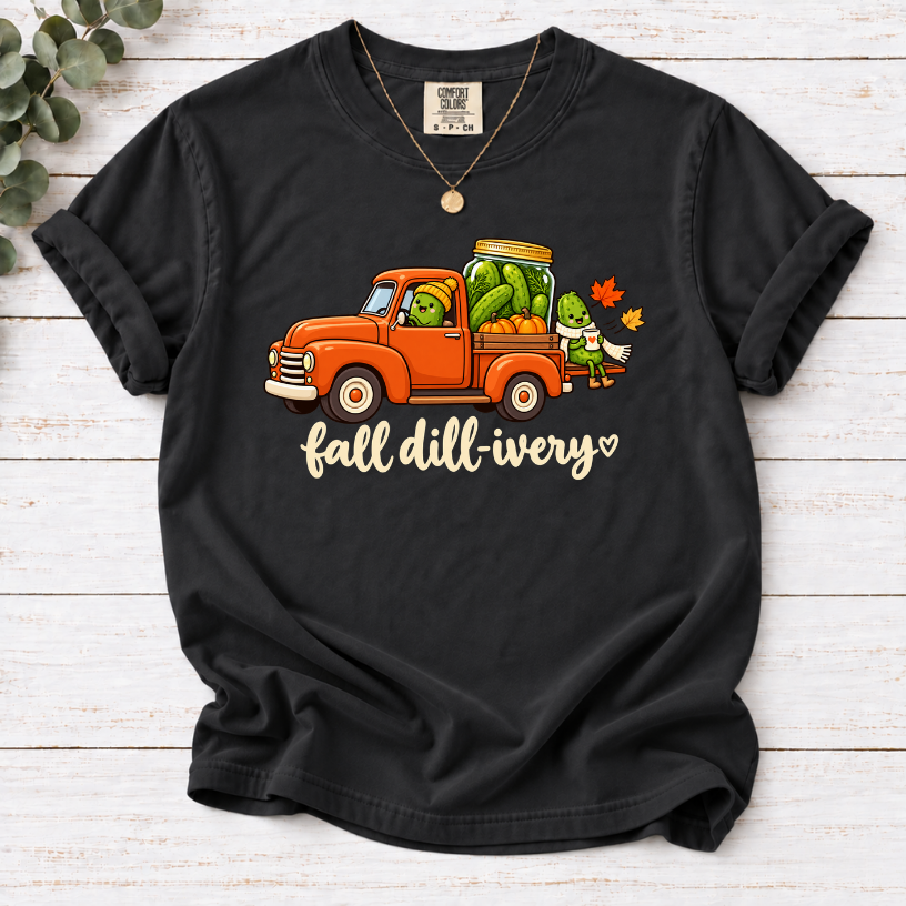 Black Fall dill-ivery’ tee featuring an orange vintage truck, pickle characters, a pickle jar, pumpkins and autumn leaves