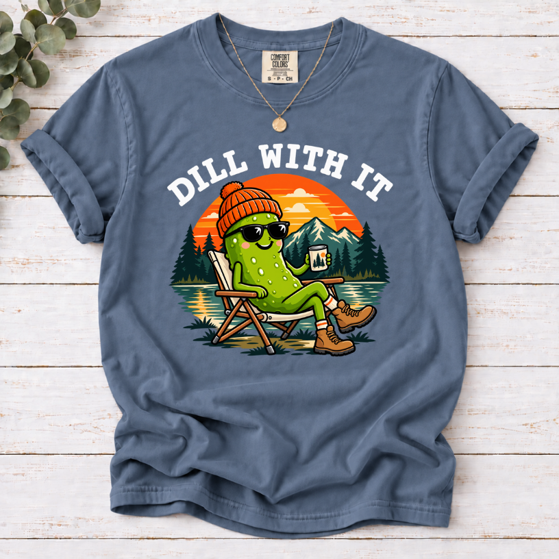 Blue Jean Dill With It T-shirt featuring a pickle in sunglasses relaxing in a camp chair beside a lake at sunset.