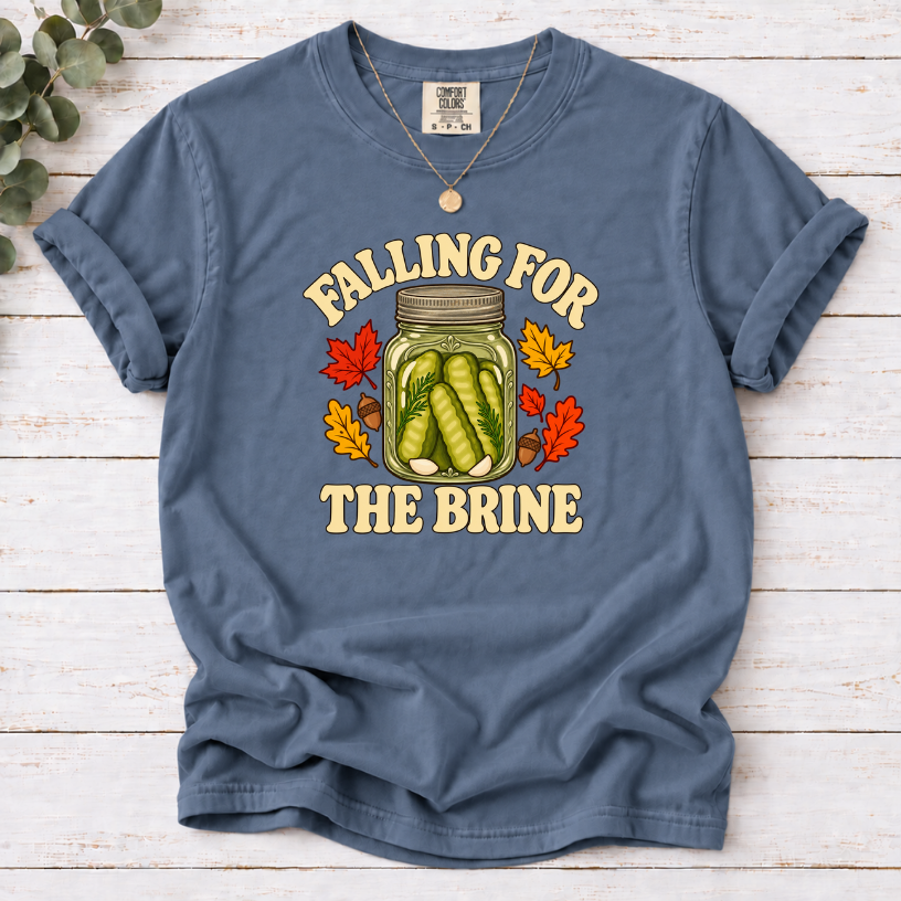 Blue Jean T-shirt with “Falling for the Brine” lettering and a pickle jar surrounded by autumn leaves and acorns.