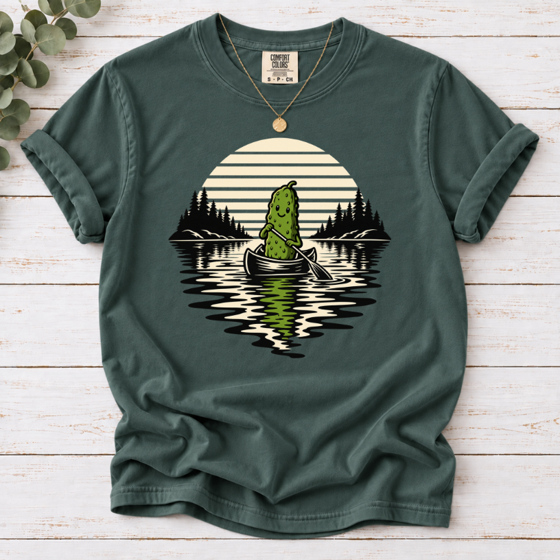Canoeing pickle under a retro sunset on a Blue Spruce T-shirt.