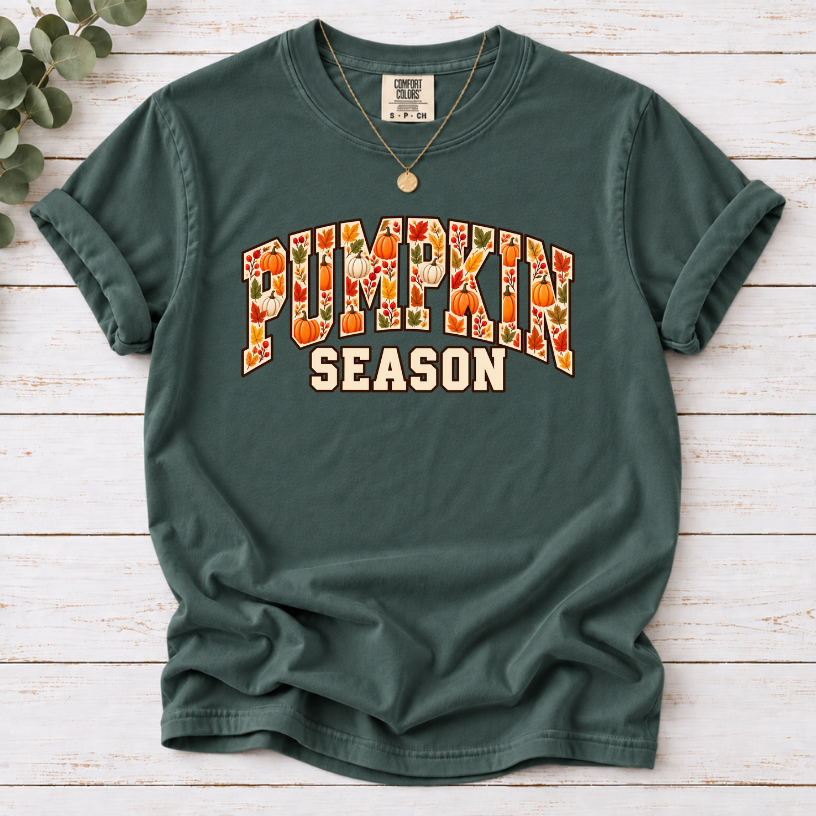 Blue Spruce T-shirt with Pumpkin Season lettering filled with orange and white pumpkins and autumn leaves.