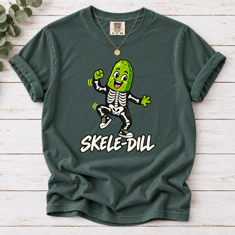 Blue Spruce Skele-Dill T-shirt featuring a dancing pickle in a skeleton costume with SKELE-DILL lettering