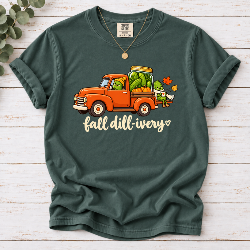 Blue Spruce Fall dill-ivery’ tee featuring an orange vintage truck, pickle characters, a pickle jar, pumpkins and autumn leaves