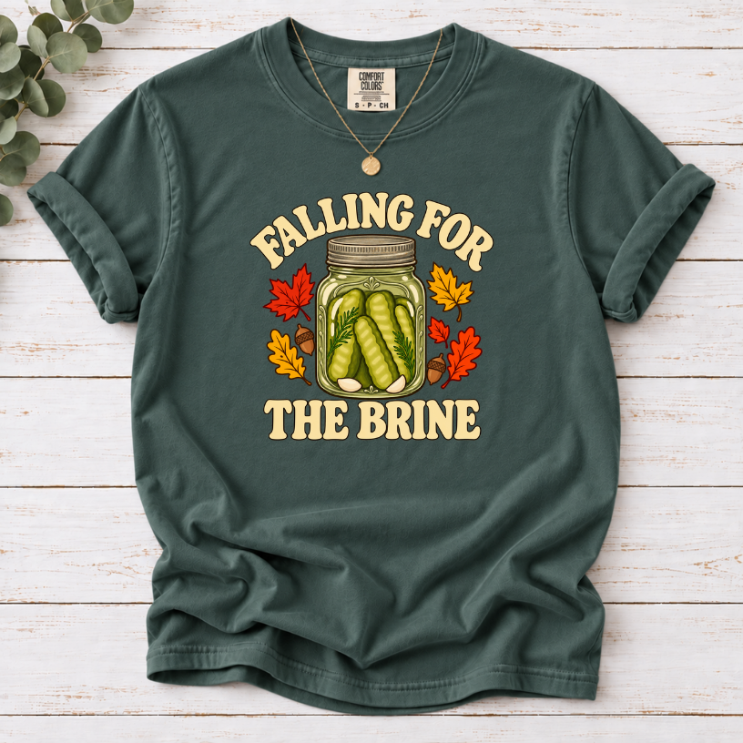 Blue Spruce T-shirt with “Falling for the Brine” lettering and a pickle jar surrounded by autumn leaves and acorns.