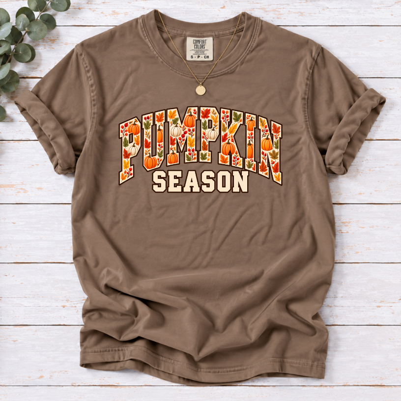 Espresso T-shirt with Pumpkin Season lettering filled with orange and white pumpkins and autumn leaves.