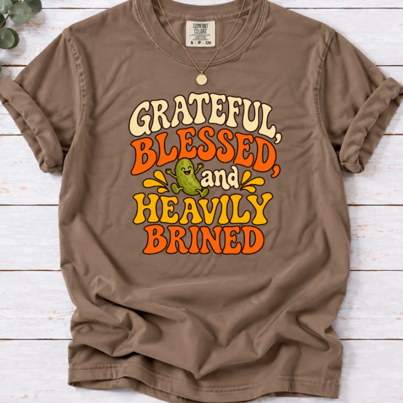 Espresso brown T-shirt with ‘Grateful, Blessed and Heavily Brined’ retro lettering and a smiling green pickle