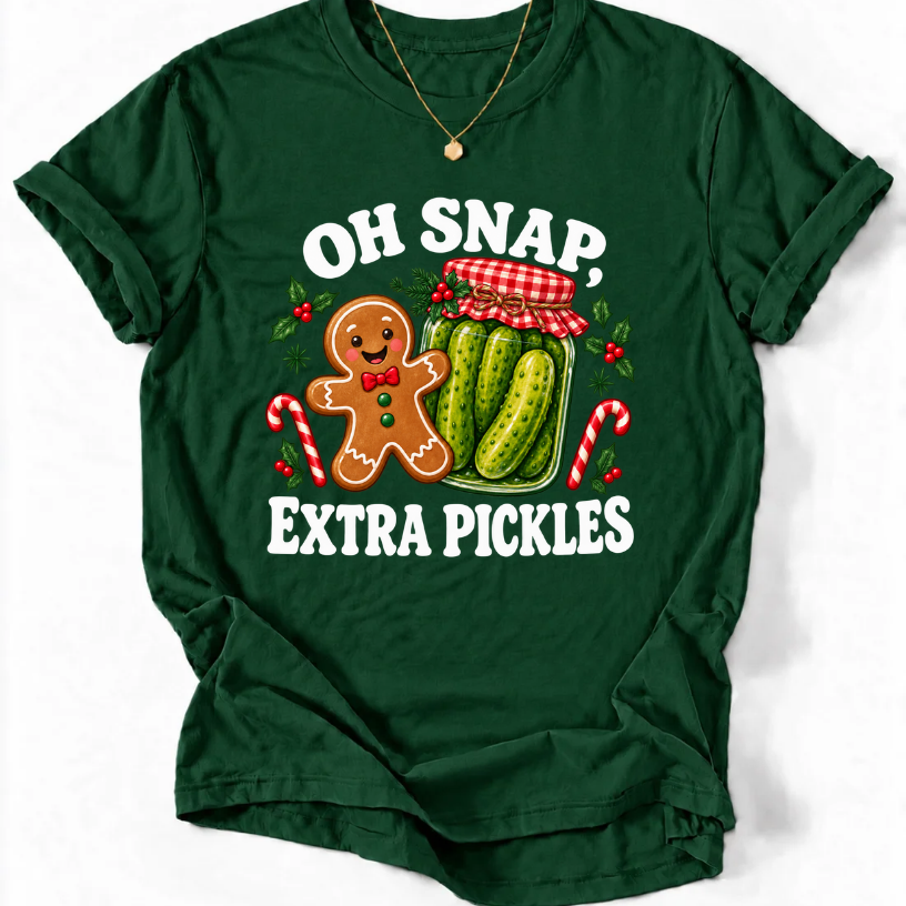 Forest Green T-shirt with “Oh Snap, Extra Pickles” lettering, a smiling gingerbread character, and a pickle jar surrounded by candy canes and holly.