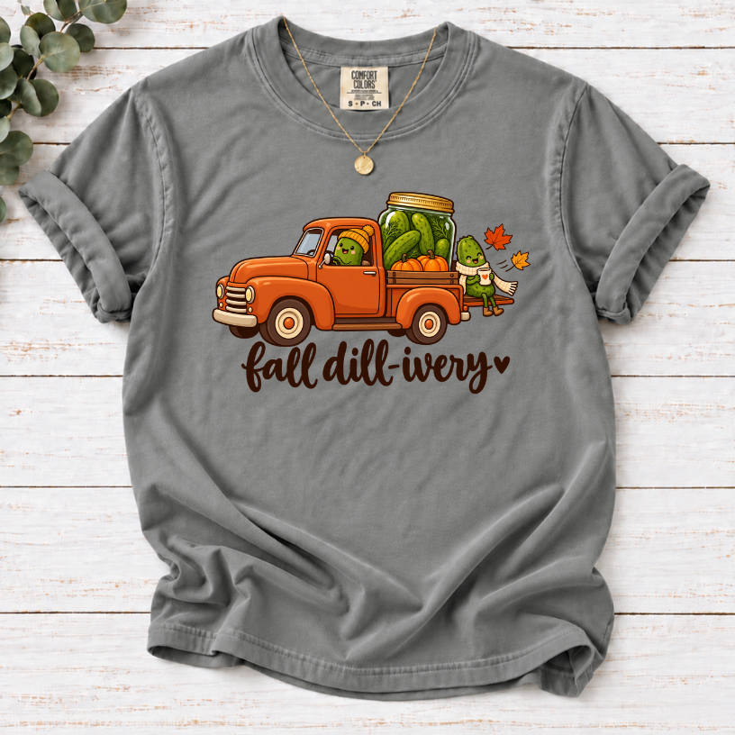 Grey Fall dill-ivery’ tee featuring an orange vintage truck, pickle characters, a pickle jar, pumpkins and autumn leaves