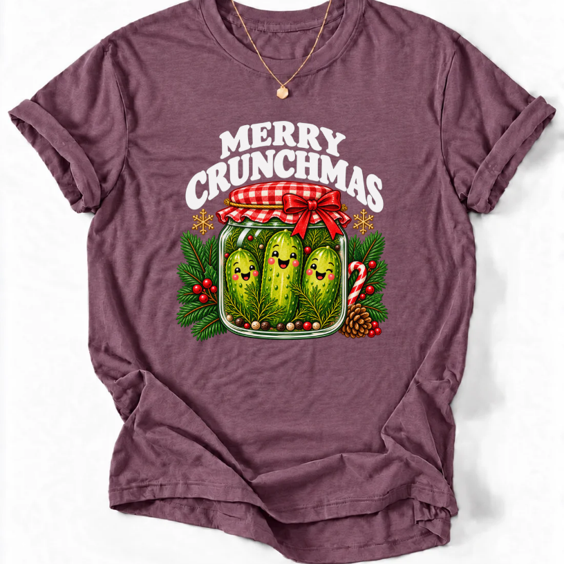 Heather Maroon T-shirt with “Merry Crunchmas” lettering above three smiling pickles in a jar decorated with a red bow and Christmas greenery.