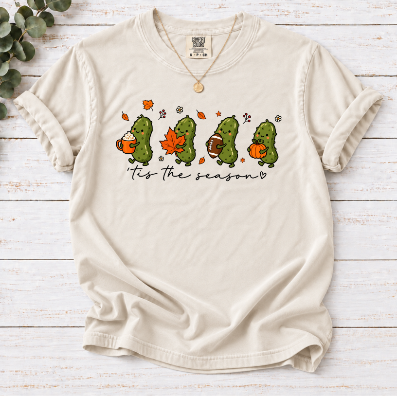 Ivory tis the season tee with four pickles holding a latte, maple leaf, football and pumpkin.