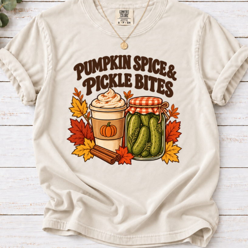 Vintage Pumpkin Spice & Pickle Bites design with dark brown lettering, a coffee cup, pickle jar, autumn leaves, and cinnamon sticks on Ivory Shirt