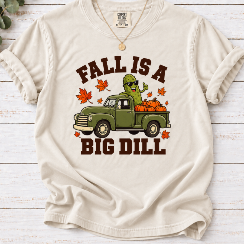 ivory Fall Is a Big Dill shirt design featuring a pickle wearing sunglasses in a vintage green pickup truck with pumpkins and autumn leaves.