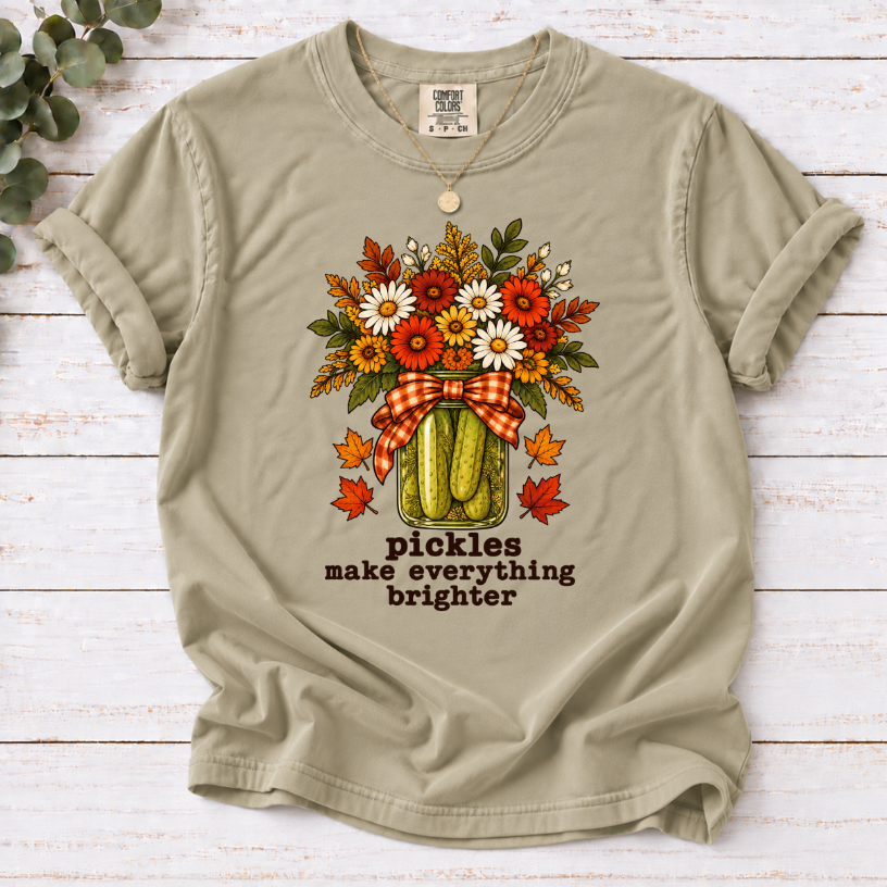 Khaki tee with pickle jar flower bouquet, gingham bow and the text “pickles make everything brighter”