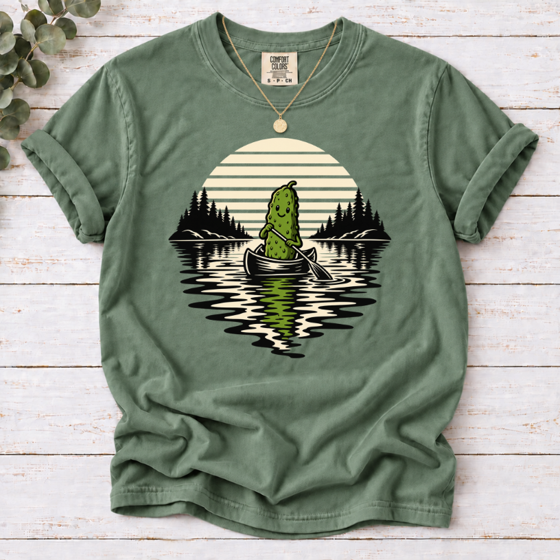 Canoeing pickle under a retro sunset on a Moss T-shirt.