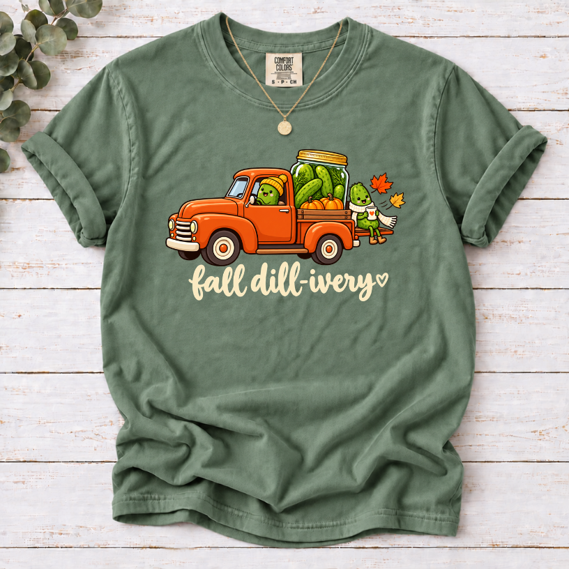 Moss Fall dill-ivery’ tee featuring an orange vintage truck, pickle characters, a pickle jar, pumpkins and autumn leaves