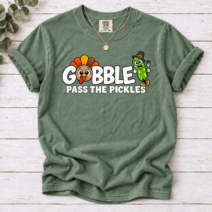 Moss T-shirt with ‘Gobble Pass the Pickles’ lettering, a cartoon turkey and a pilgrim pickle holding a fork.