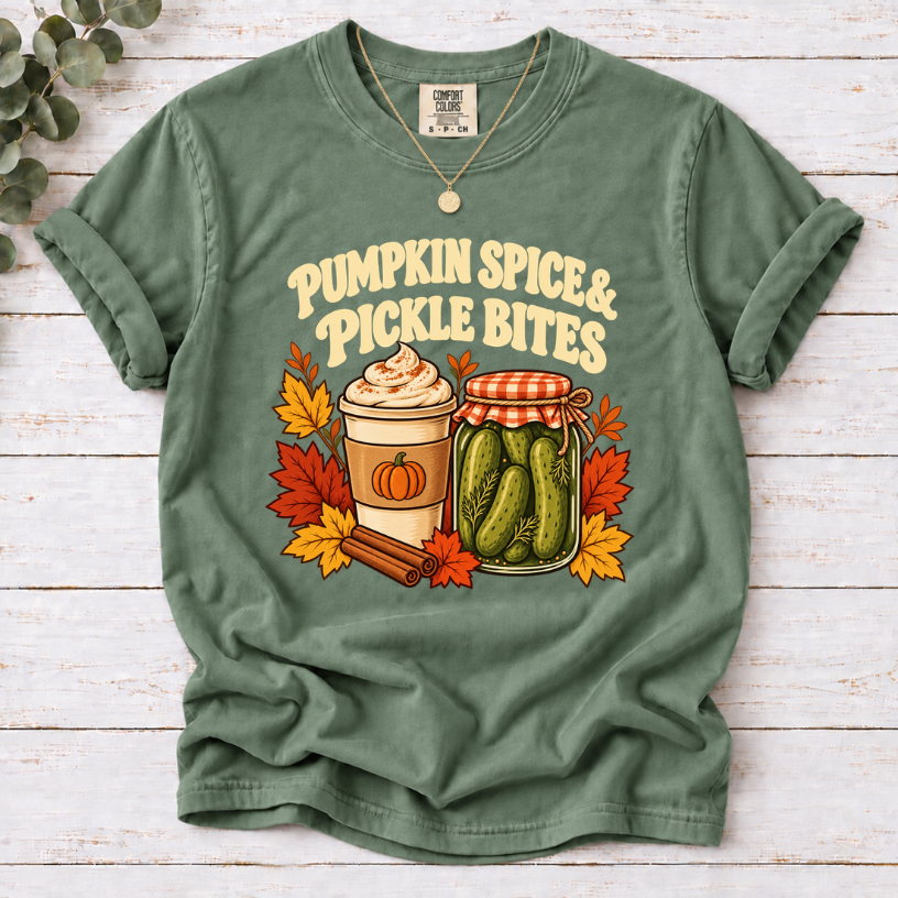 Vintage Pumpkin Spice & Pickle Bites design with dark brown lettering, a coffee cup, pickle jar autumn leaves, and cinnamon sticks on Moss Shirt