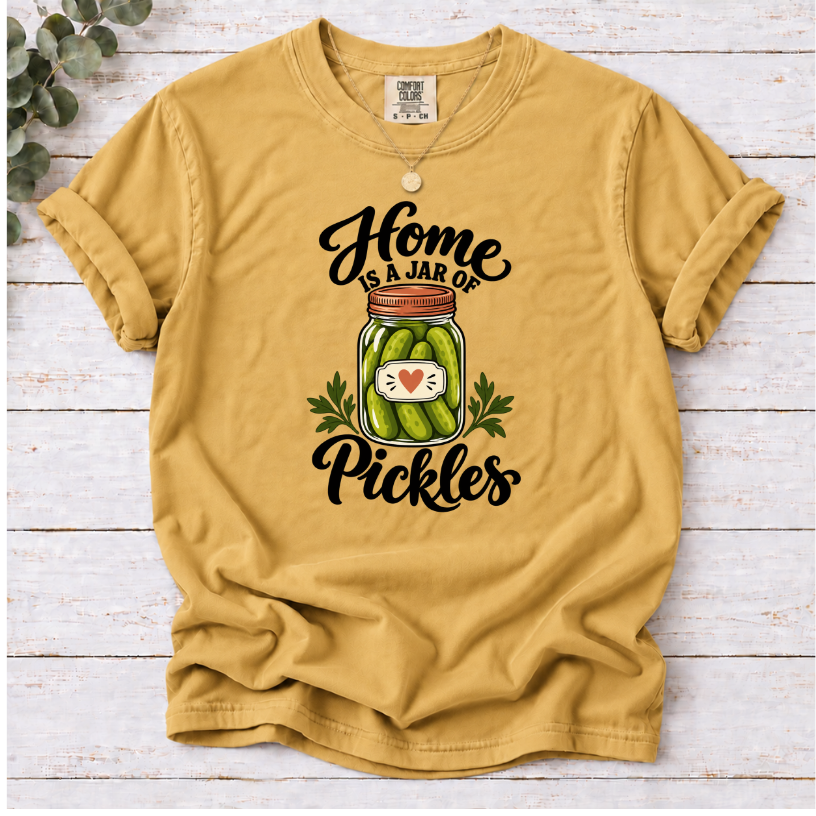 Mustard T-shirt with a heart-labeled pickle jar graphic and black ‘Home Is a Jar of Pickles’ lettering