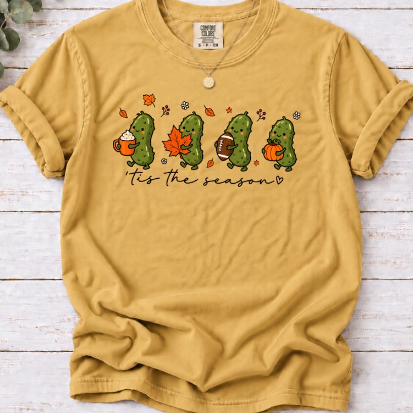 Mustard yellow ’tis the season tee with four pickles holding a latte, maple leaf, football and pumpkin.