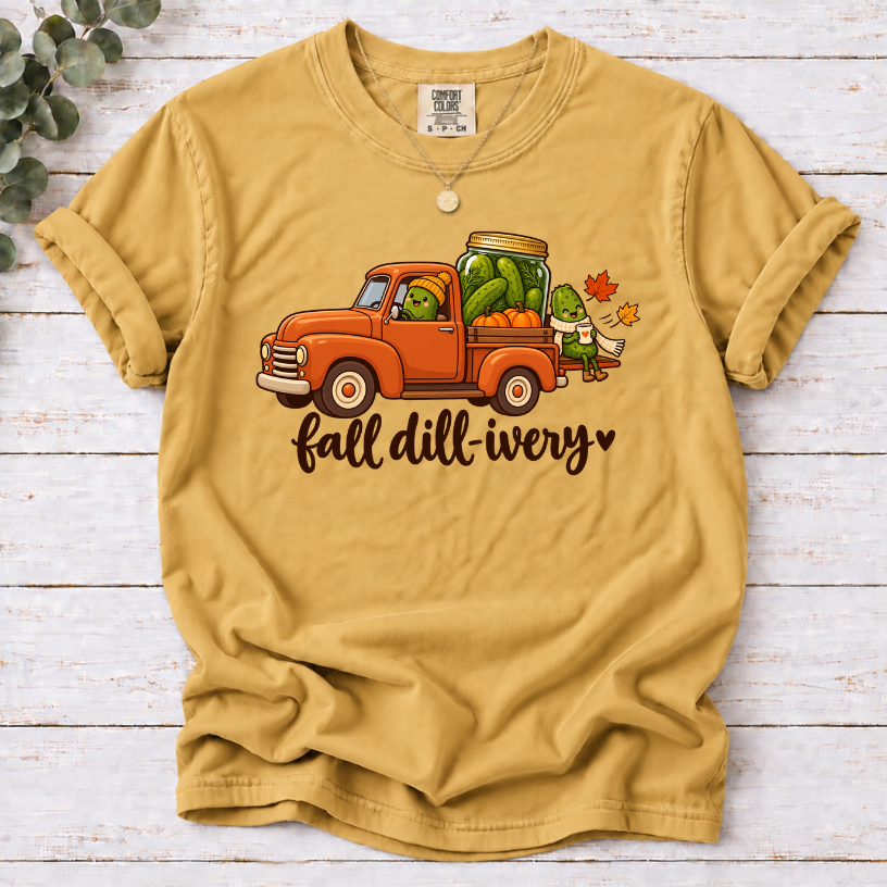Mustard Fall dill-ivery’ tee featuring an orange vintage truck, pickle characters, a pickle jar, pumpkins and autumn leaves