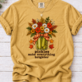 Mustard tee with pickle jar flower bouquet, gingham bow and the text “pickles make everything brighter”
