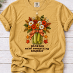 Mustard tee with pickle jar flower bouquet, gingham bow and the text “pickles make everything brighter”