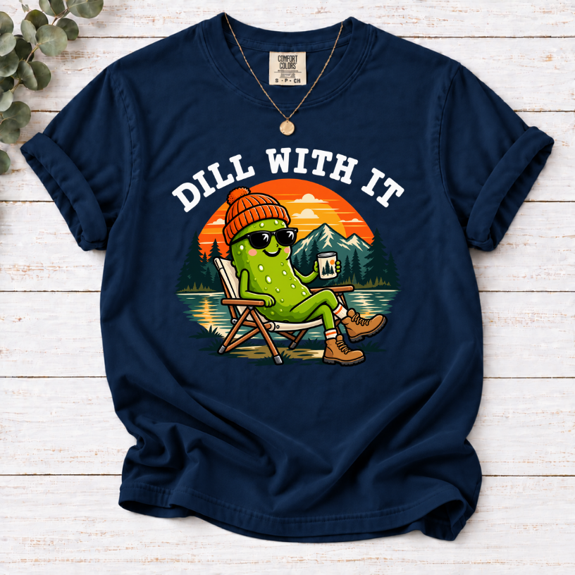 Navy Dill With It T-shirt featuring a pickle in sunglasses relaxing in a camp chair beside a lake at sunset.