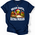 Navy ‘Dear Santa, Extra Pickles’ T-shirt featuring a Santa-hat pickle writing a letter beside cookies and pickles.”