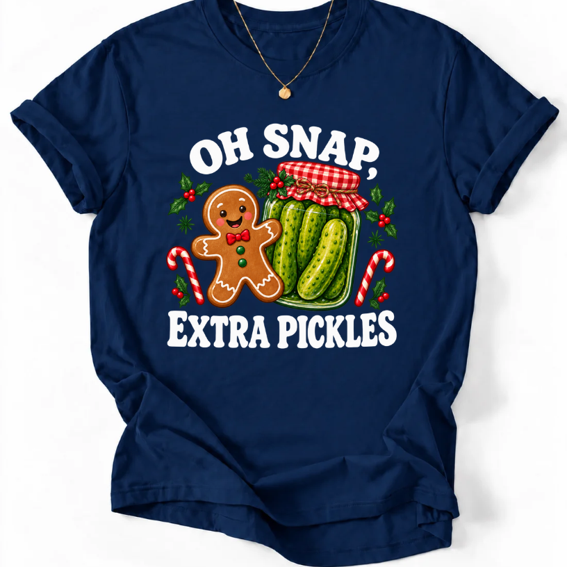 Navy T-shirt with “Oh Snap, Extra Pickles” lettering, a smiling gingerbread character, and a pickle jar surrounded by candy canes and holly.