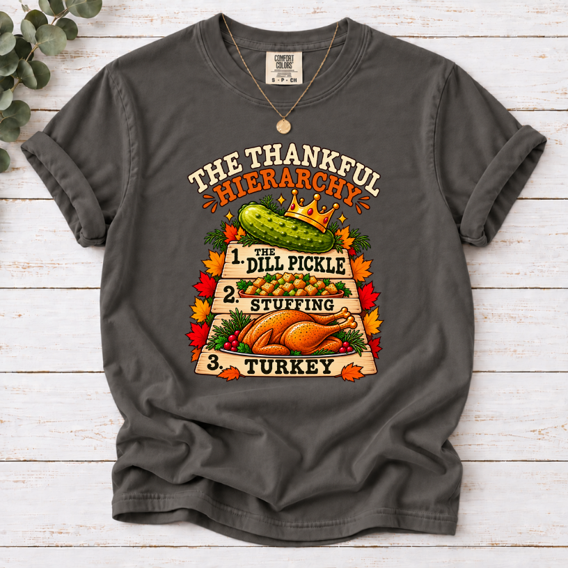 Pepper T-shirt with The Thankful Hierarchy design featuring a crowned dill pickle, stuffing, turkey, and fall leaves
