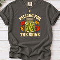 Pepper charcoal T-shirt with “Falling for the Brine” lettering and a pickle jar surrounded by autumn leaves and acorns.
